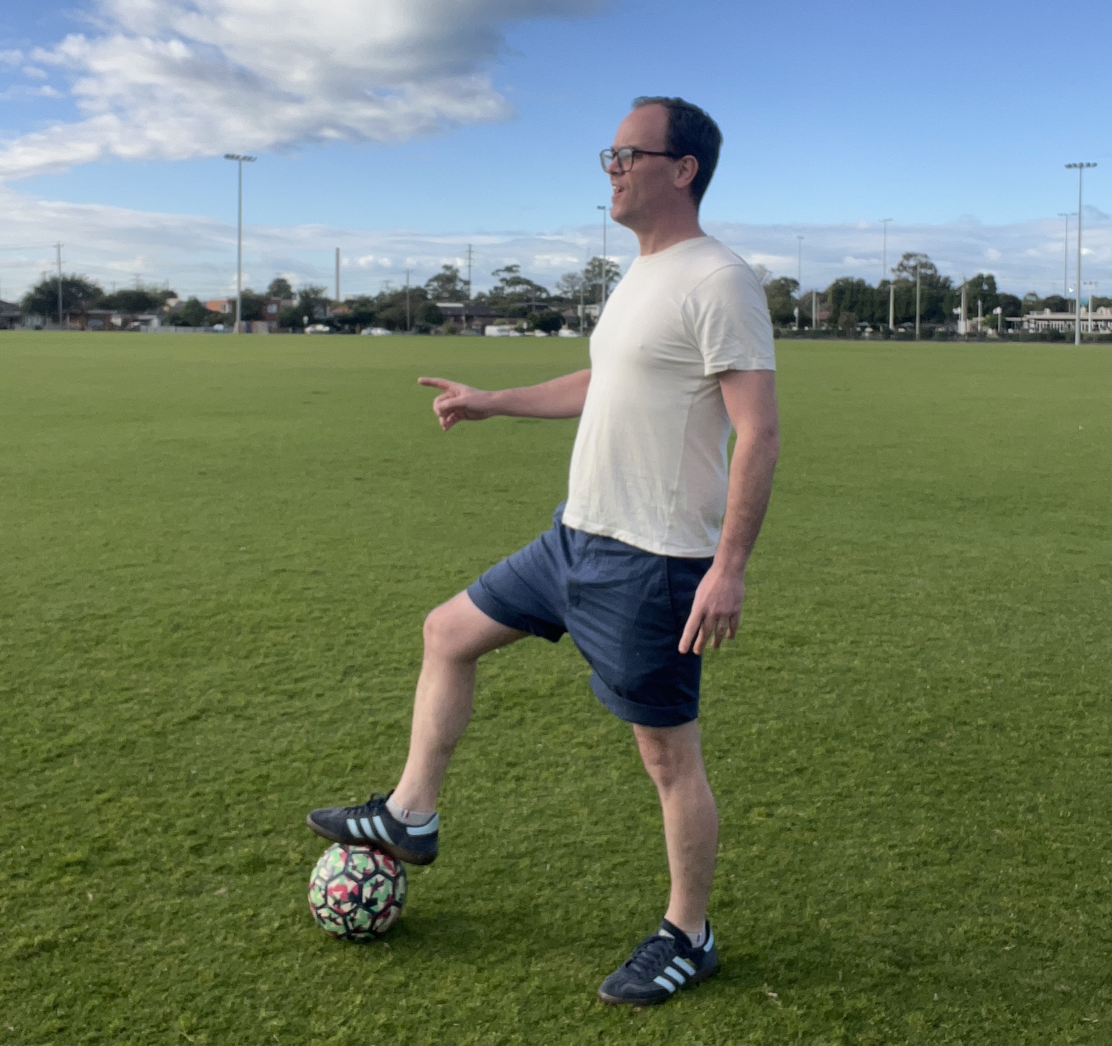 Max pointing at a soccer ball on a field